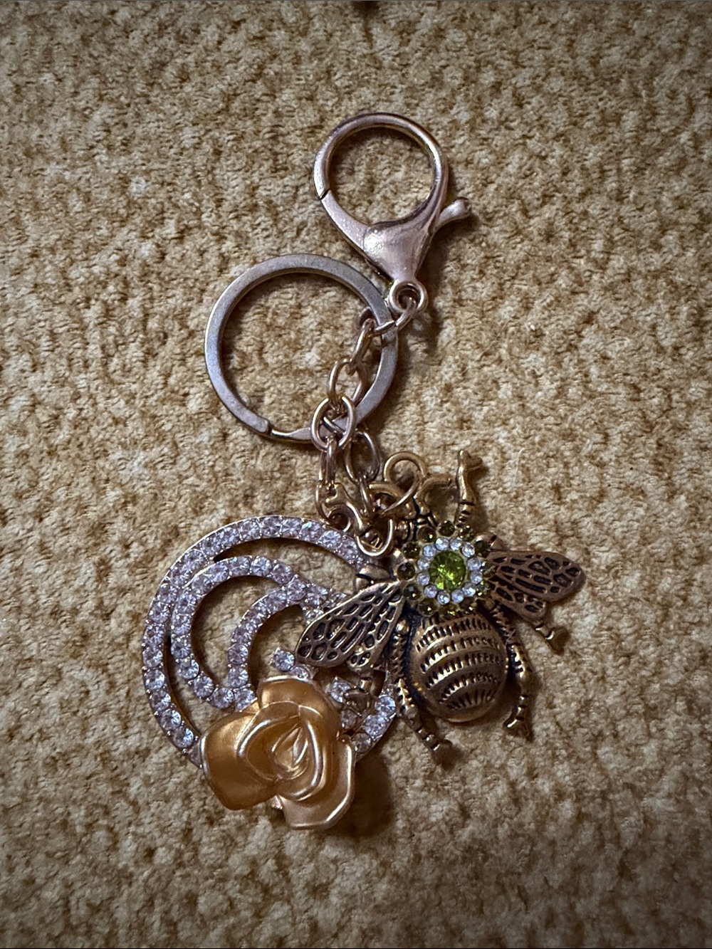 Handmade keychain with a large metal bee adorned with a green center rhinestone